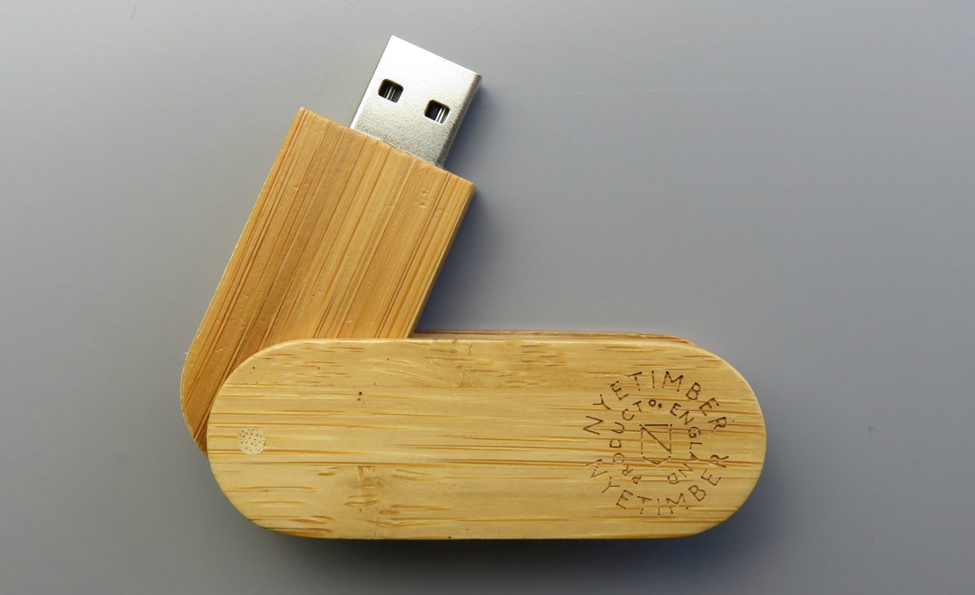 Wooden USB with NyeTimber engraved logo on grey background