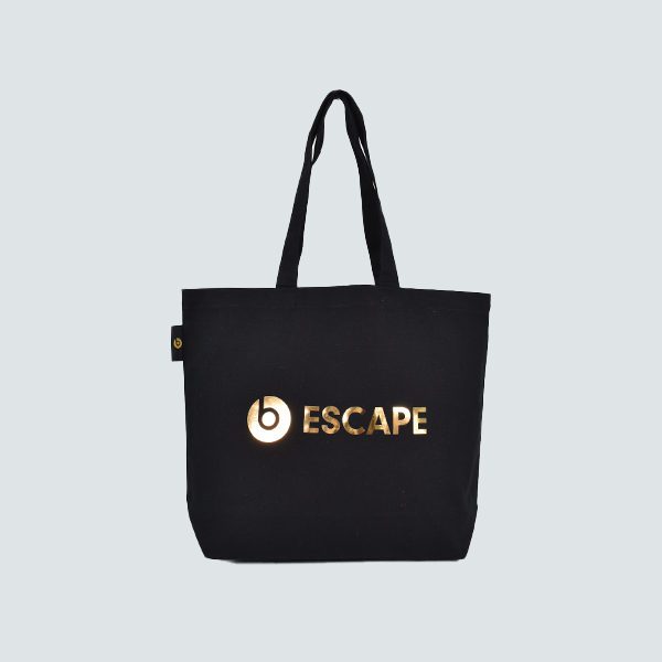 black square shopping bag with gold mirror logo ESCAPE on grey background