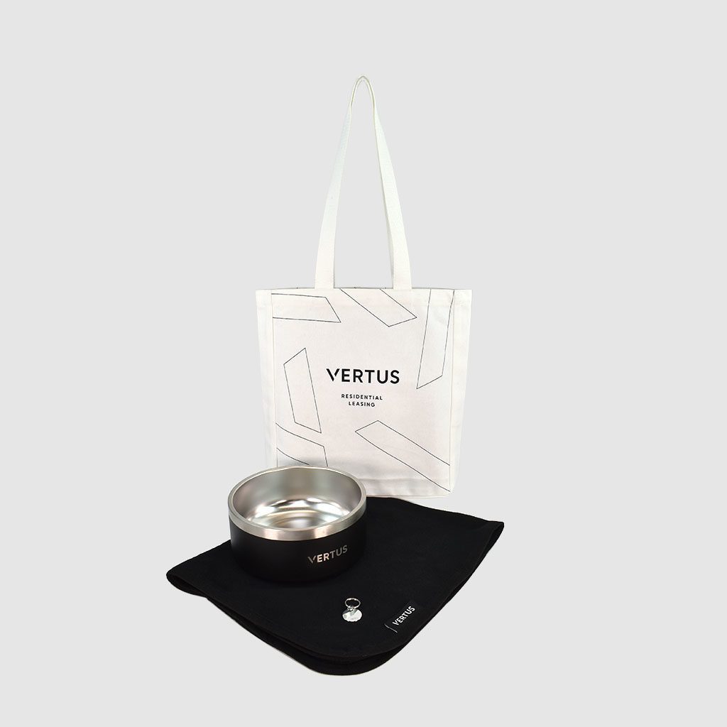luxury merchandise gifts Bespoke branded merchandise collection of white cotton tote bag, black branded dog blanket, white enamel keyring and personalised metal dog bowl