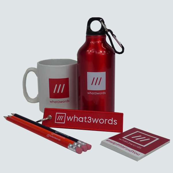 what 3 words branded accessories collection of red and white branded merchandise over printed with What3Words logo