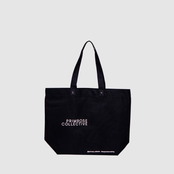 black tote bag with white text print PRIMROSE COLLECTIVE