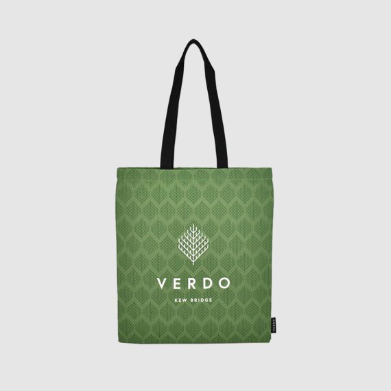 green tote bag with white print all over and black handles