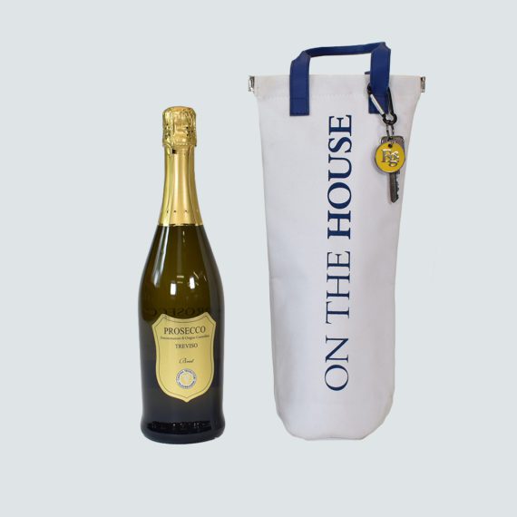 white bottle bag with blue handles and prosecco bottle next to it