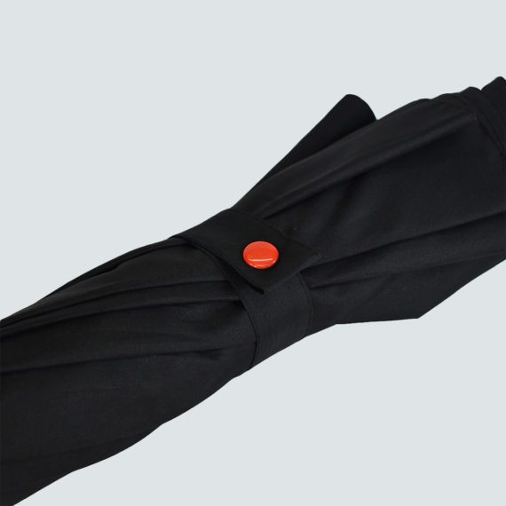 black umbrella with red popper closure